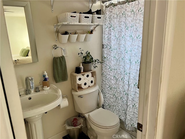 bathroom featuring tile floors, sink, and toilet