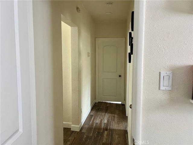 corridor featuring dark wood-type flooring