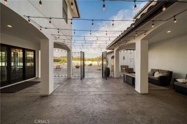 patio terrace at dusk featuring an outdoor living space