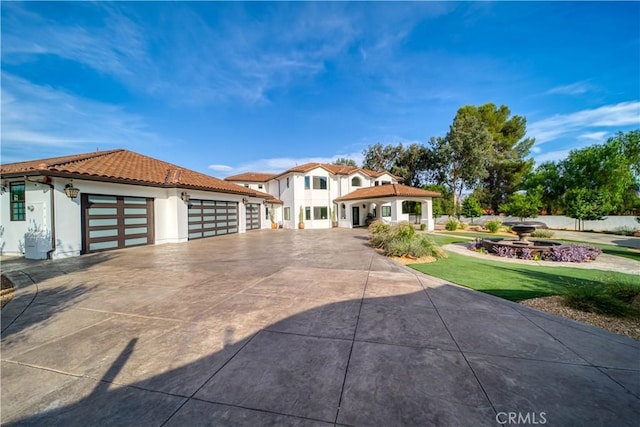 mediterranean / spanish home with a front yard