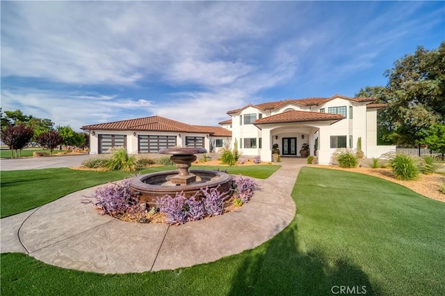 back of property featuring a garage and a yard