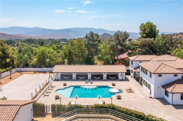 view of swimming pool with a mountain view and a patio