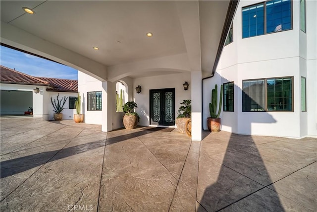 view of exterior entry featuring a patio and french doors