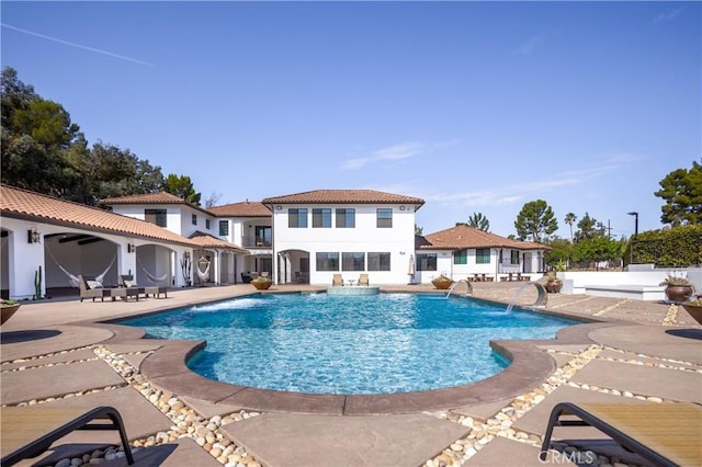 view of swimming pool with a patio and pool water feature