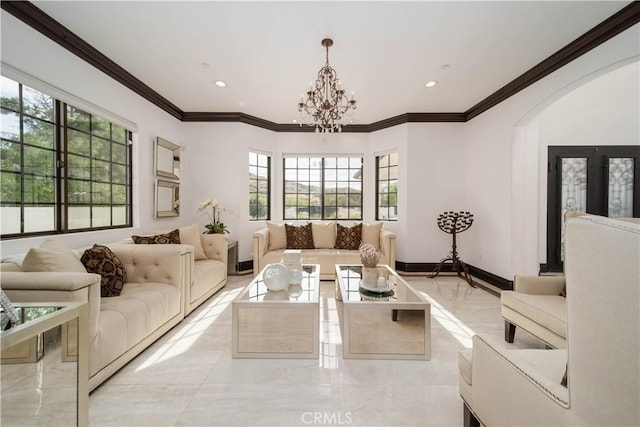 living room with an inviting chandelier, crown molding, and plenty of natural light