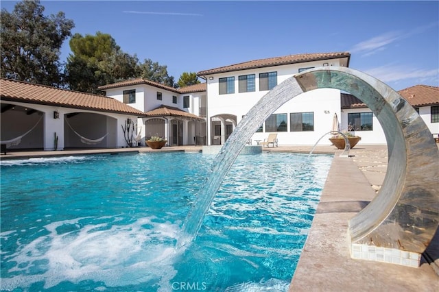 view of pool featuring a patio and pool water feature