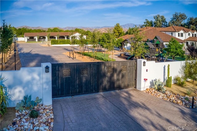 view of gate featuring a mountain view