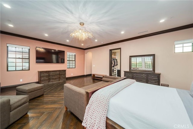 bedroom featuring crown molding, dark parquet flooring, a spacious closet, and a notable chandelier