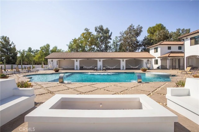 view of pool featuring a patio, outdoor lounge area, and pool water feature