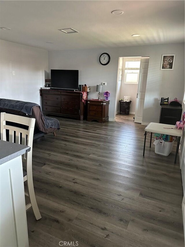 bedroom with dark wood-type flooring
