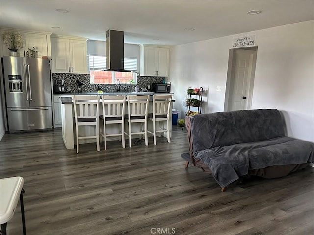 living room with dark hardwood / wood-style flooring and sink