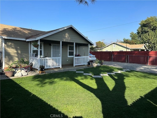 view of front of home with covered porch and a front lawn