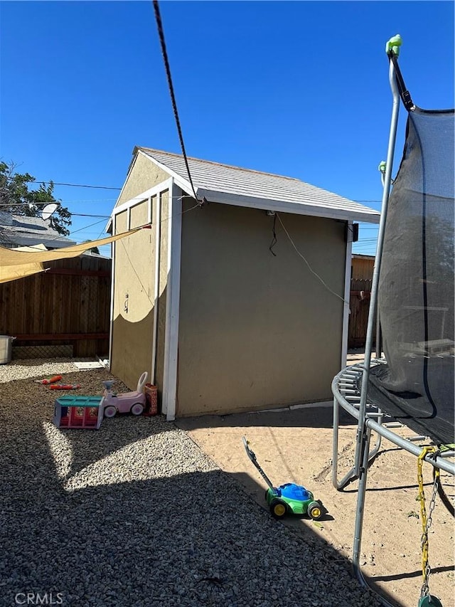 view of side of home featuring a trampoline