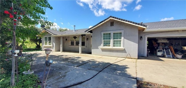 rear view of house with a garage