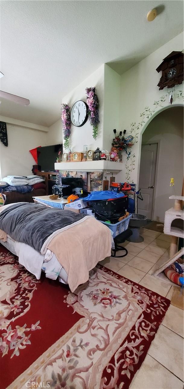 bedroom featuring tile patterned floors and a textured ceiling