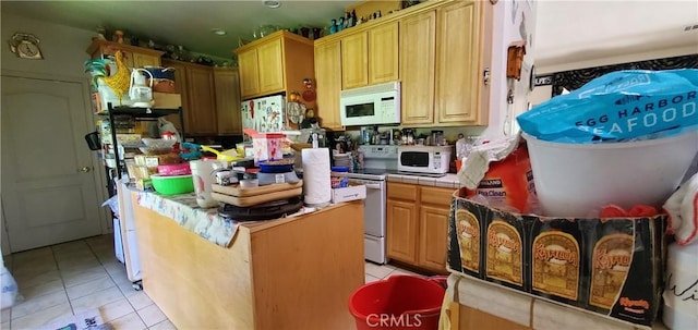 kitchen with tile countertops, light tile patterned floors, and white appliances