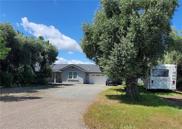 view of front of house featuring a garage and a front lawn