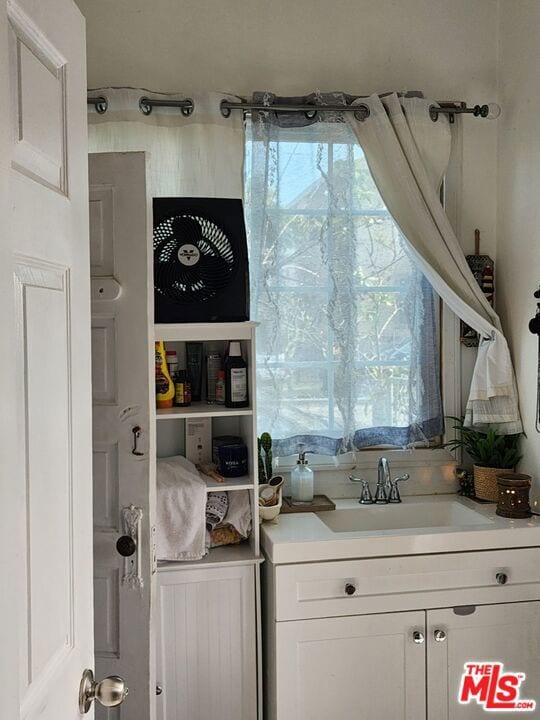 interior space with white cabinets and sink