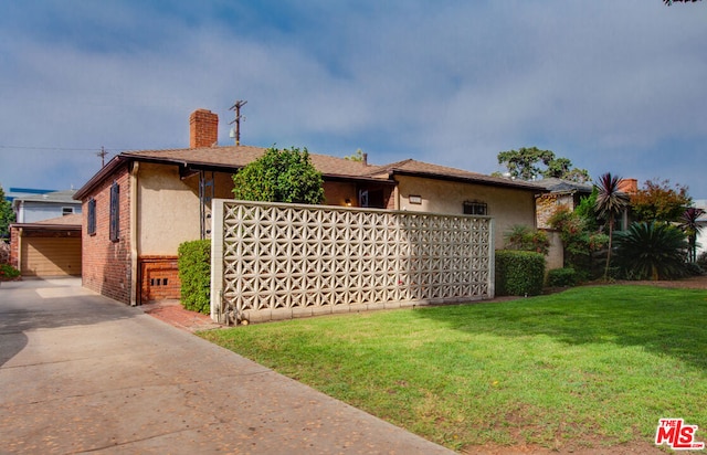 view of side of home with a lawn and a garage