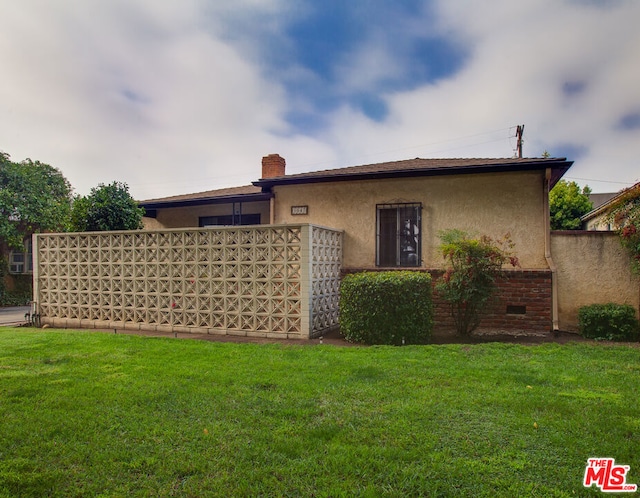 view of property exterior with a yard