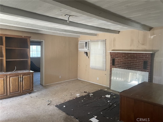 unfurnished living room with beamed ceiling and a wall mounted air conditioner