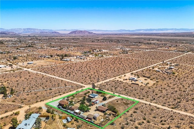 aerial view featuring view of desert, a mountain view, and a rural view