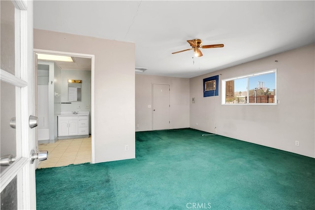 spare room featuring carpet and ceiling fan