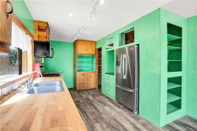 kitchen featuring track lighting, open shelves, dark wood-style floors, stainless steel fridge with ice dispenser, and a sink
