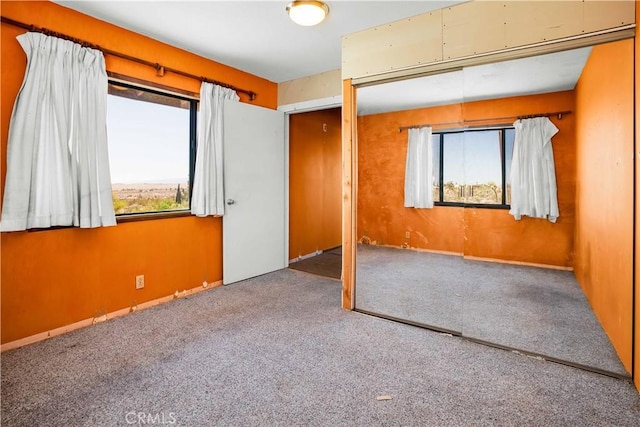 unfurnished bedroom with carpet and a closet