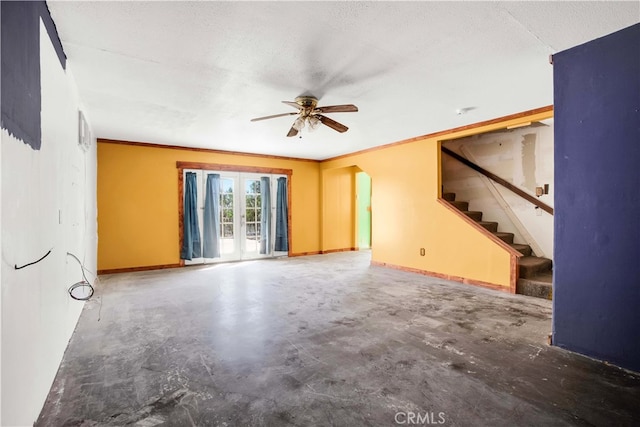 unfurnished living room featuring ceiling fan and a textured ceiling