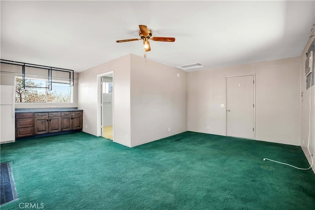 interior space with carpet floors and ceiling fan