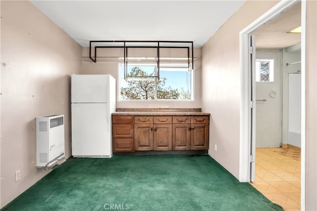 kitchen with white fridge and tile floors