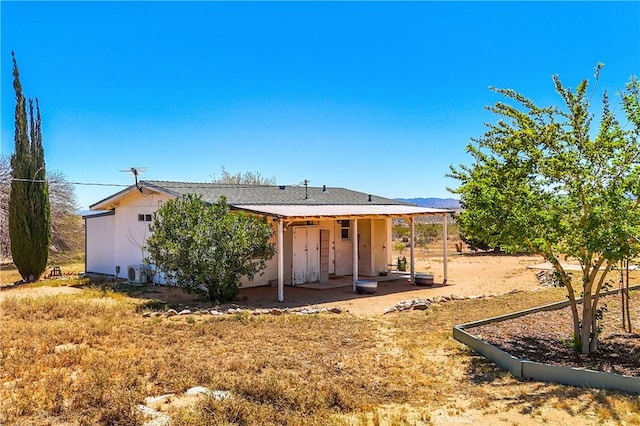 back of property with a patio