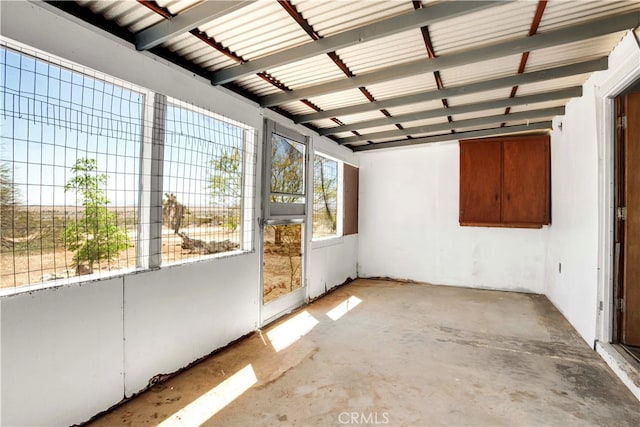 unfurnished sunroom with beamed ceiling