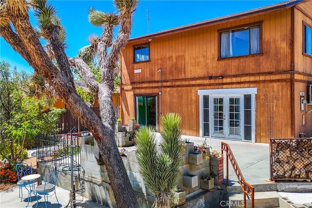 back of house with fence, a patio, and french doors