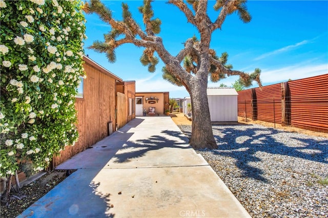 exterior space featuring a patio area and a storage shed