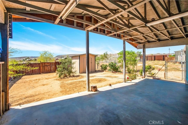 view of patio featuring a shed