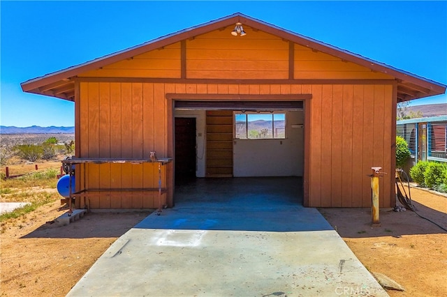 view of front facade with an outdoor structure and a mountain view