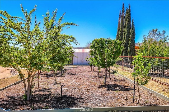 view of yard featuring fence and an outdoor structure
