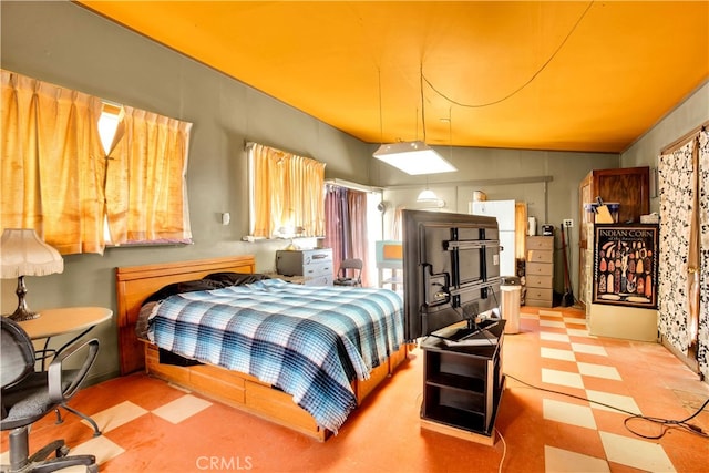 bedroom featuring light tile flooring and lofted ceiling