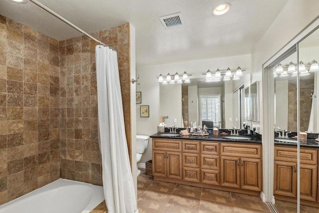 full bathroom with vanity, tile patterned floors, toilet, a textured ceiling, and shower / tub combo with curtain