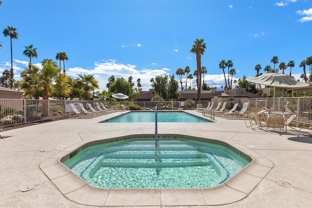 view of pool with a patio area and a community hot tub