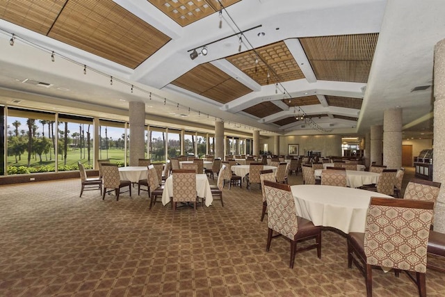 dining space with carpet flooring and vaulted ceiling