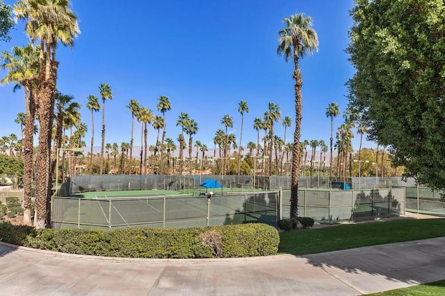 view of tennis court with a yard