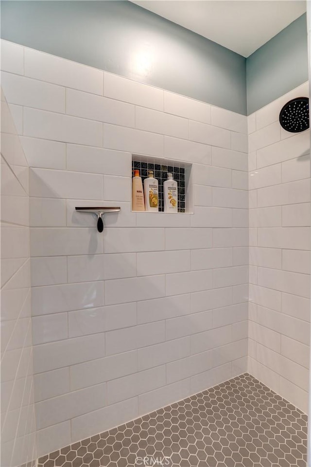 bathroom with a tile shower