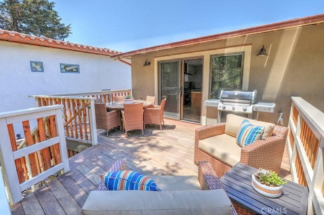 wooden deck featuring an outdoor living space and grilling area