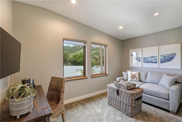 carpeted living room with vaulted ceiling