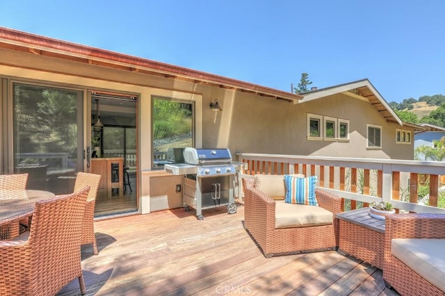 wooden terrace featuring grilling area