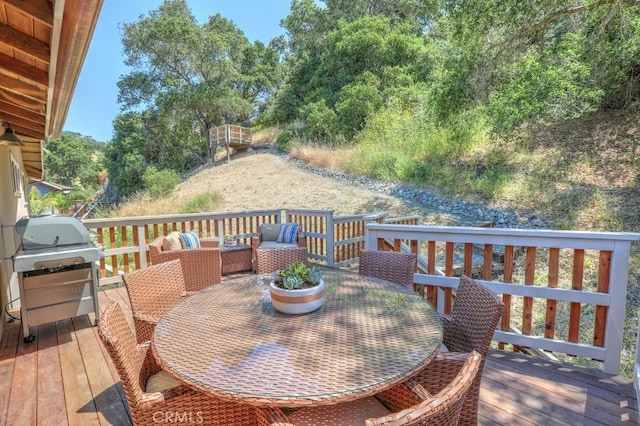 wooden terrace featuring a grill