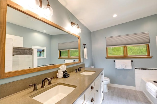 full bathroom featuring toilet, vanity, and plus walk in shower